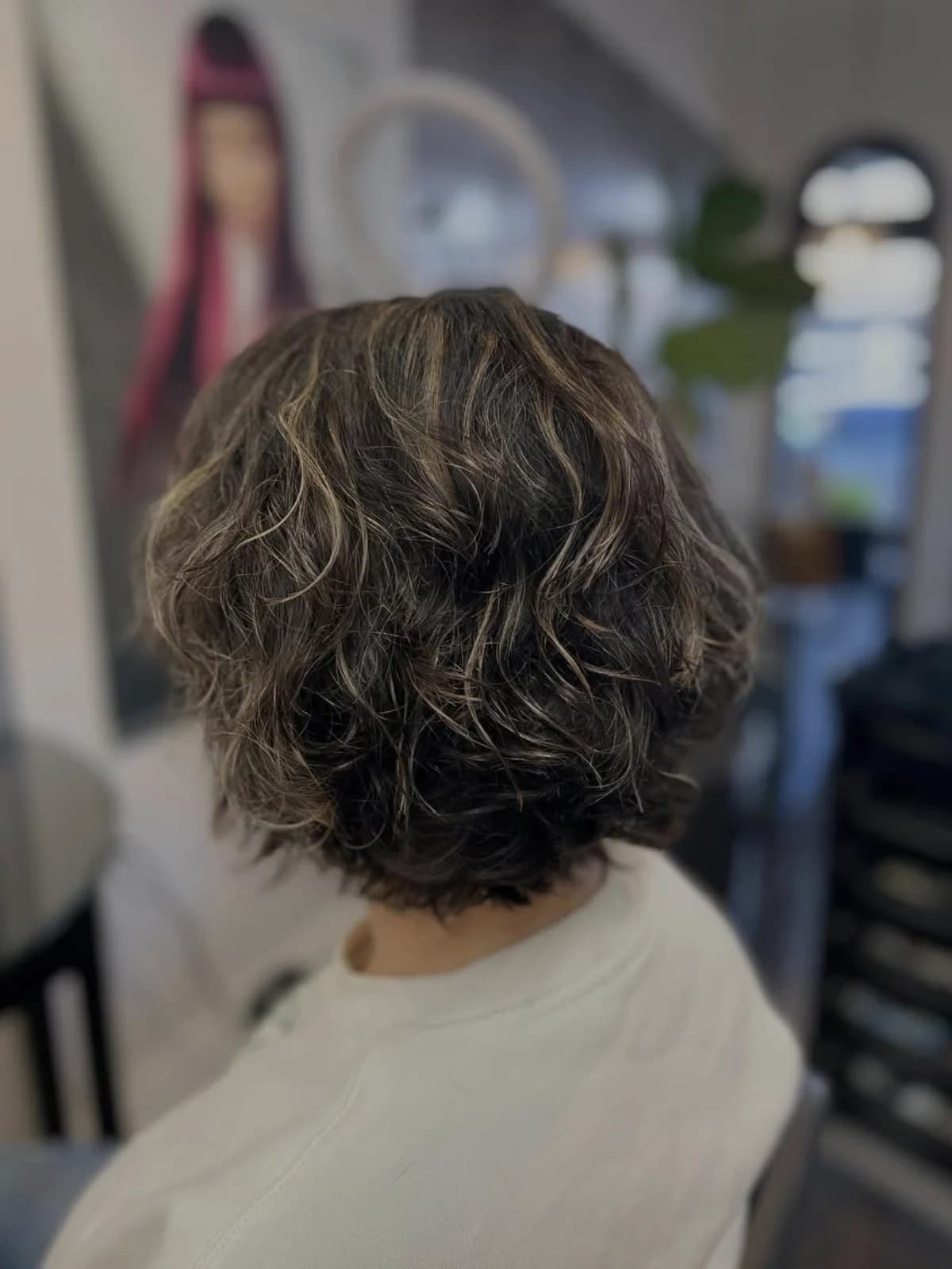 Curly highlighted bob, back view